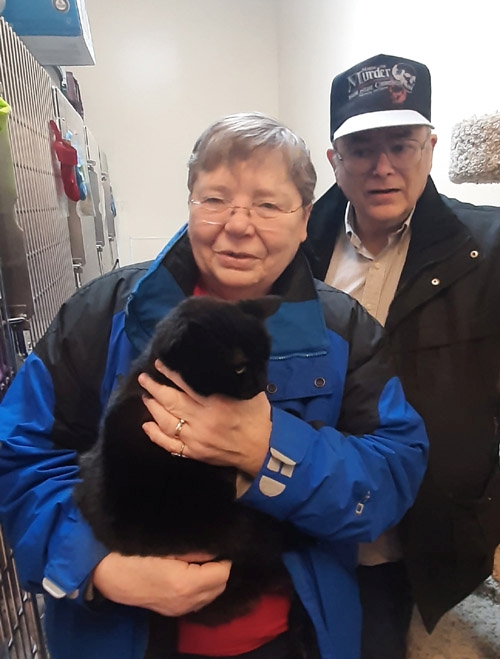 Cat with adopting family: Nellie